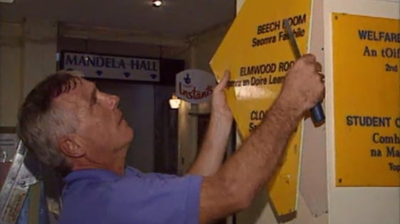 Staff remove bilingual signs from the Students' Union at Queen's University Belfast, 1997.
