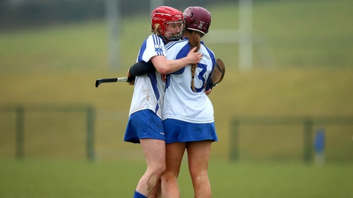 Aine Lyng (red helmet) embraces Niamh Rockett