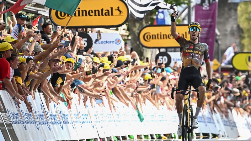 Jumbo-Visma's Christophe Laporte celebrates as he cycles to the finish line to win the 19th stage