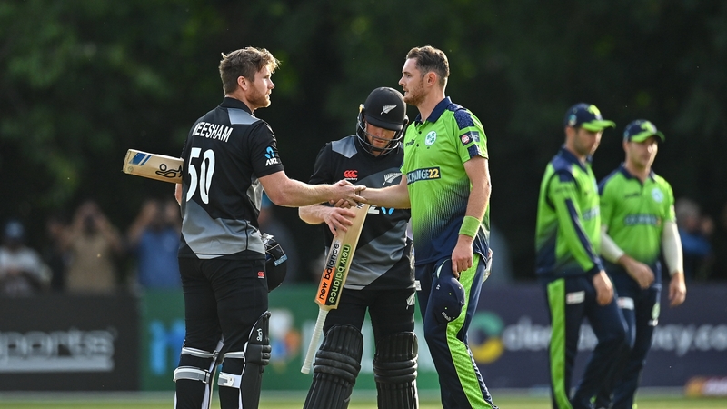 Jimmy Neesham of New Zealand (l) and Mark Adair shake hands afterwards