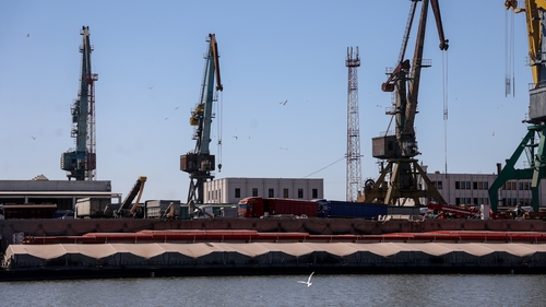 Grain carriers wait to reload cargo to barges at Reni river port on the Danube river in the Odesa region