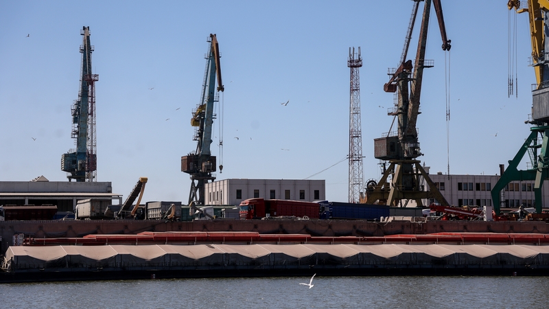 Grain carriers wait to reload cargo to barges at Reni river port on the Danube river in the Odesa region