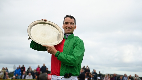 Patrick Mullins with the plate after riding Echoes In Rain to win the Connacht Hotel Handicap