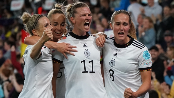 Alexandra Popp (No 11) is mobbed after scoring the winner