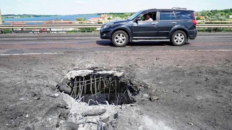 A crater on Kherson's Antonivskiy bridge across the Dnipro river caused by Ukraine rocket fire