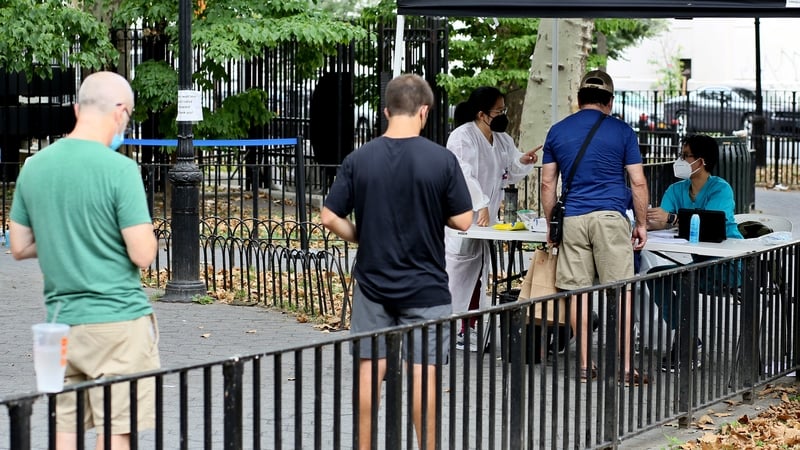 People wait in line to register for a monkeypox vaccination in New York
