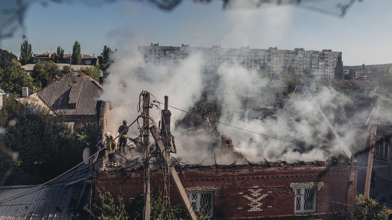 Firefighters try to extinguish a fire in a shelled house in Bakhmut, Ukraine, today