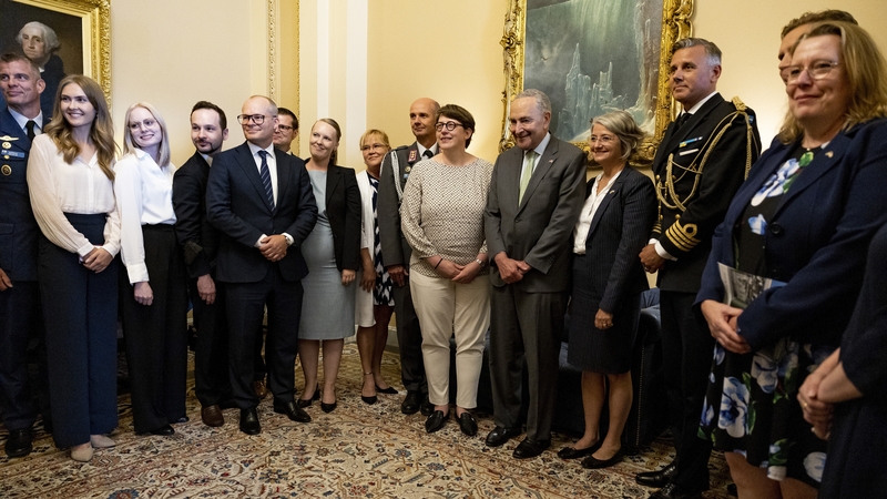 Senate Majority Leader Chuck Schumer poses for a photo with an official delegation from Finland and Sweden before the vote