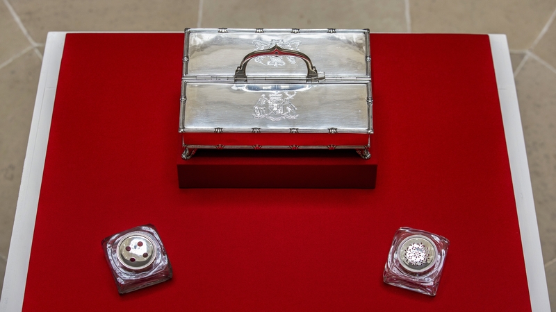 Inkstand comprises of a silver box and two small bottles