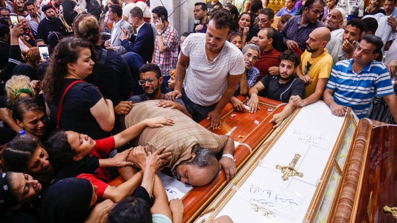 Mourners at the funeral of victims who died due to the fire that broke out at the Abu Sifin church