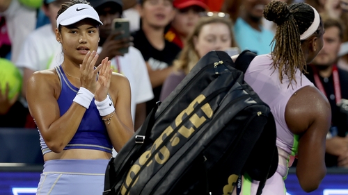 Emma Raducanu watches as Serena Williams leaves the court