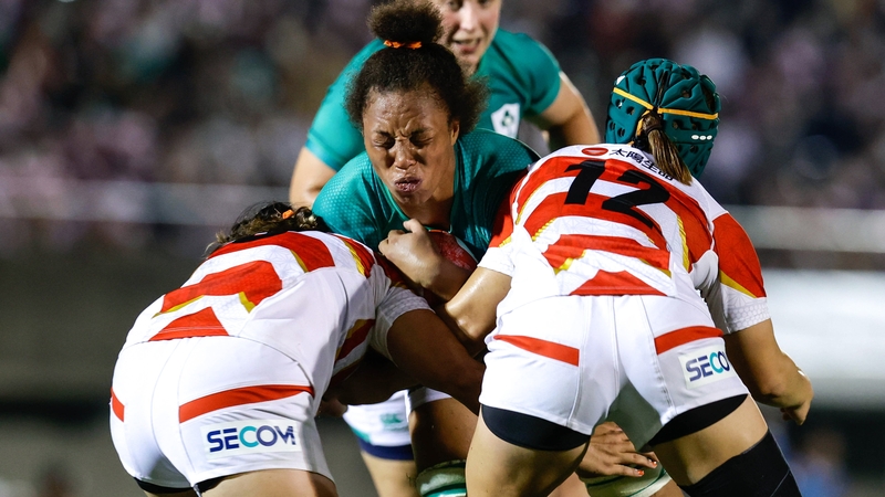 Grace Moore of Ireland is tackled by Mana Furata and Shione Nakayama of Japan