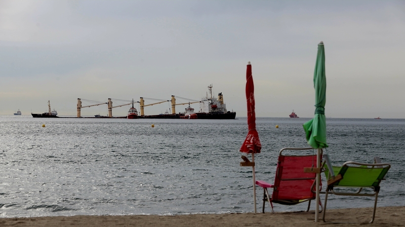 A boom - a temporary floating barrier used to contain an oil spill - has been placed in the area of the collision