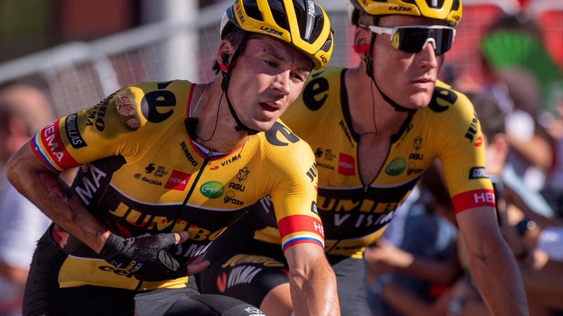 Primoz Roglic (L) crosses the line injured alongside his Team Jumbo-Visma team-mate Mike Teunissen