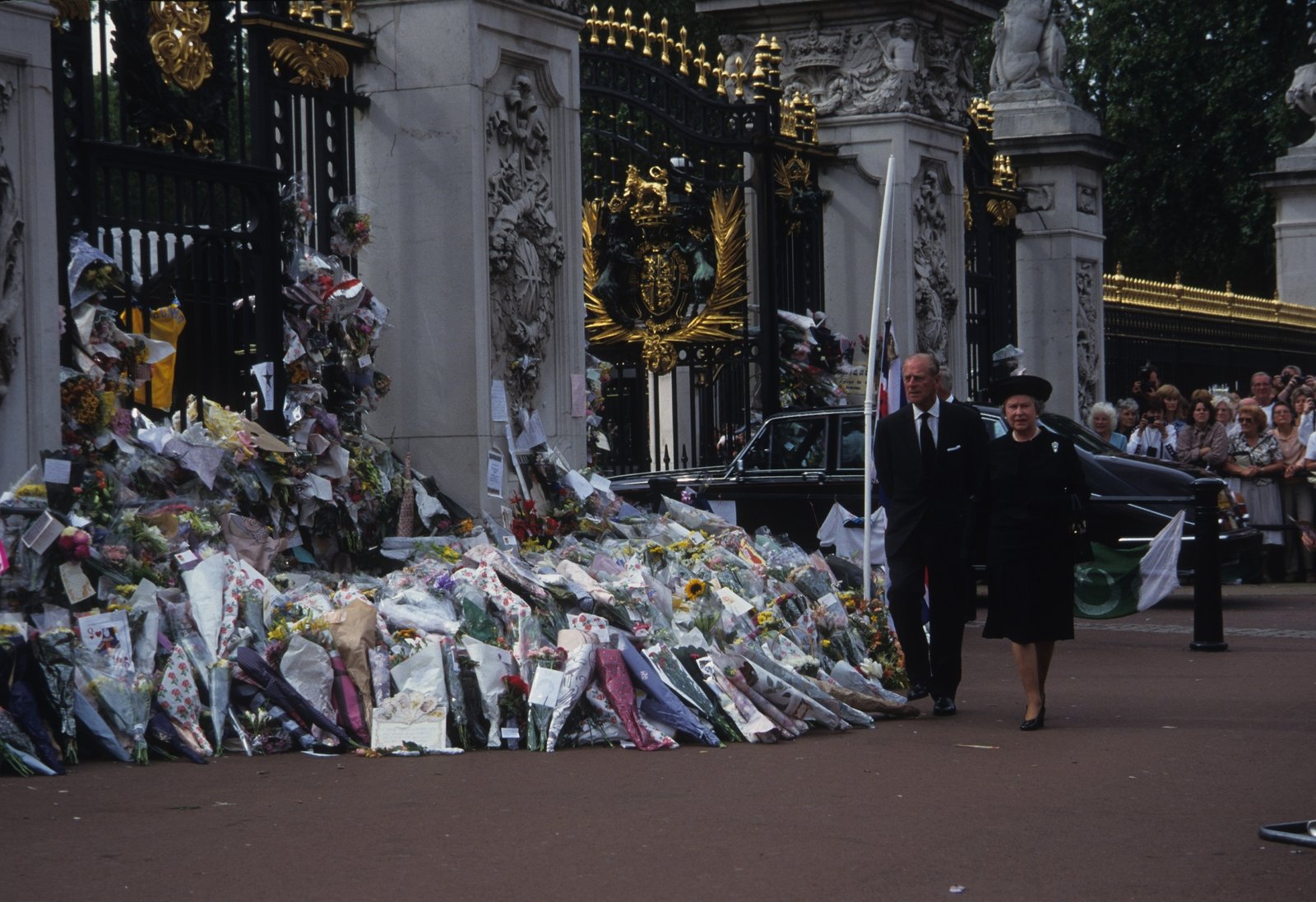 The queen walks past tributes from the British public to Princess Diana in 1997. The monarch had faced criticism for not properly judging the mood of the British people in the aftermath of Diana's death in a Paris car crash