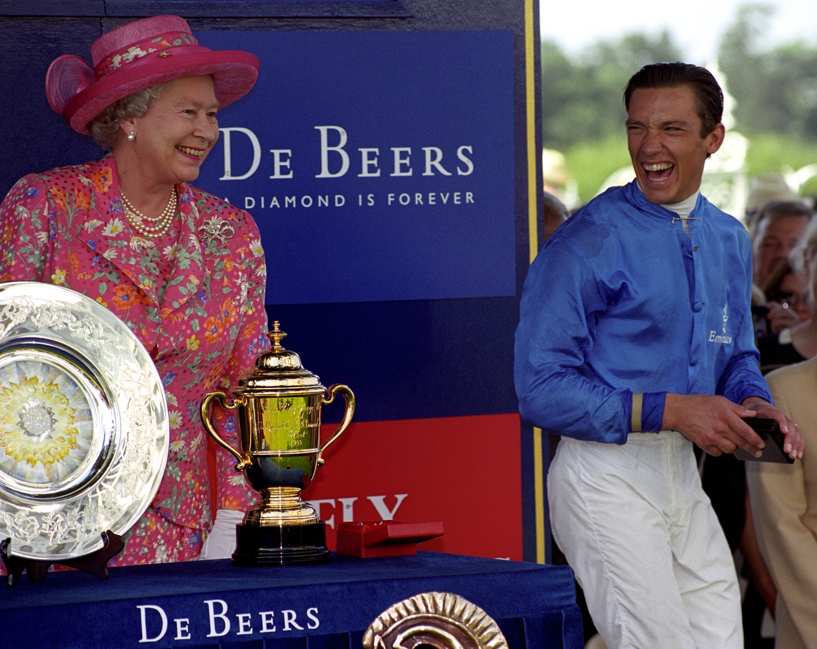 The queen presents jockey Frankie Dettori with his medal after King George VI & Queen Elizabeth Diamond Stakes in 1999. Her keen interest in racing meant that she was a regular presence at the big meetings. She was also a highly successful racehorse owner