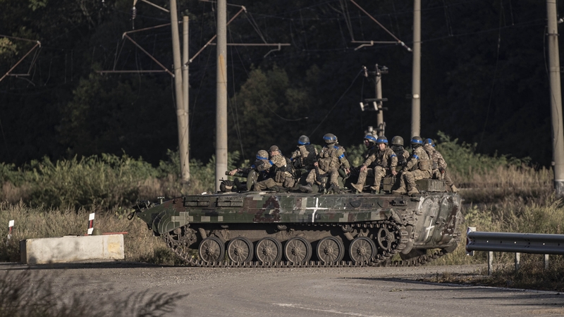 Ukrainian soldiers on patrol today after their army took control of some of the villages near Kharkiv