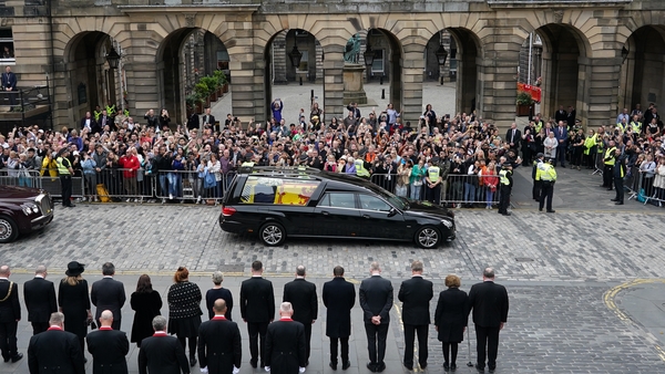 Crowds watch the cortege carrying the coffin of Queen Elizabeth II as it arrives at the Palace of Holyroodhouse in Edinburgh