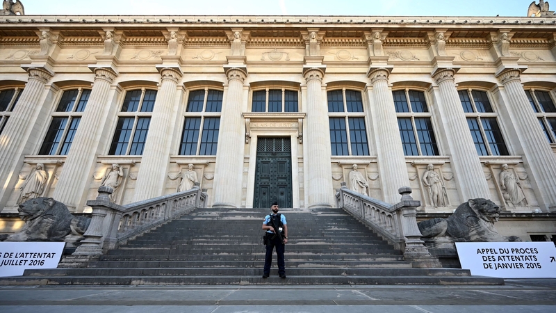 A guard stands outside the courthouse in Paris