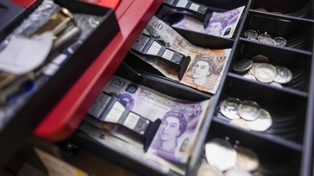 a cash register with sterling coins and notes in it