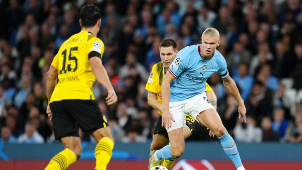 Manchester City striker Erling Haaland is challenged by Niklas Sule of Borussia