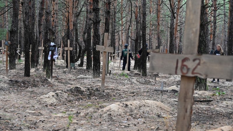 Workers exhume bodies at mass burial sites in Izium earlier this month, after Ukrainian forces liberated the area from Russia