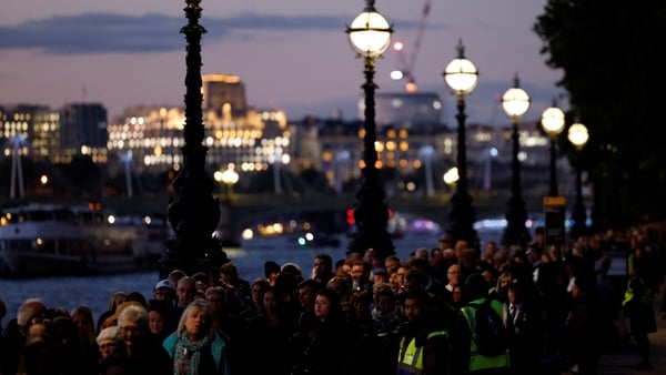 Members of the public queue to attend the queen's lying in state