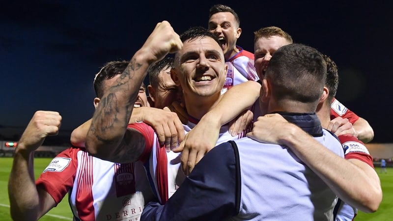Enda Curran, centre, celebrates with team-mates after scoring Treaty United's second goal