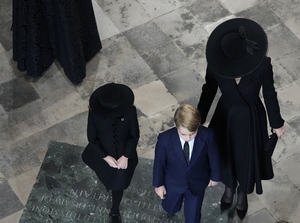Mourning clothes: Princess of Wales Kate with her children Prince George and Princess Charlotte at the church (Frank Augstein/WPA)