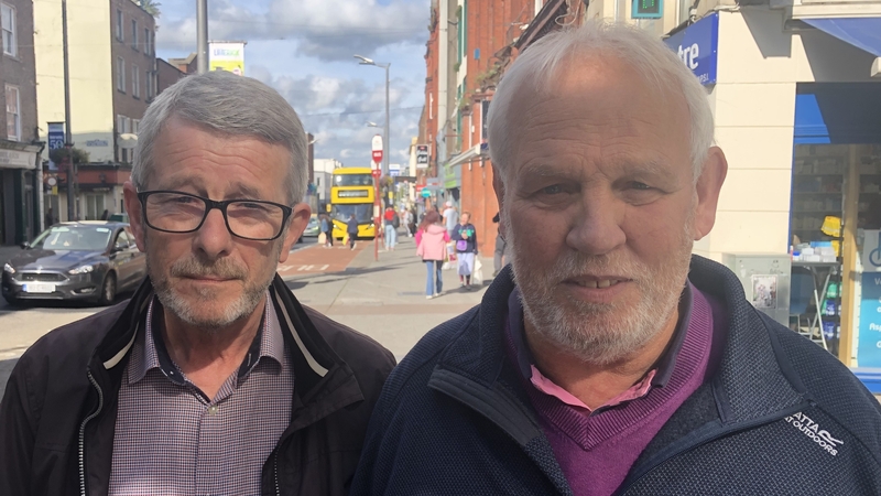 Noel Ryan (left) and Brian O'Grady talking to reporter Cathy Halloran in Limerick city today