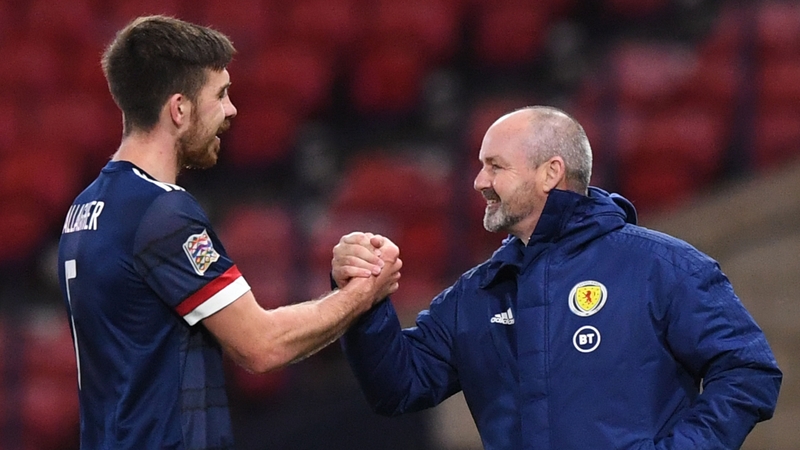Declan Gallagher (L) shakes hands with Scotland's head coach Steve Clarke (R)