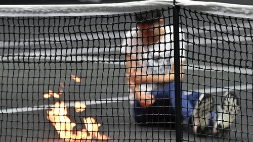 A protester invaded the court and appeared to set his arm alight