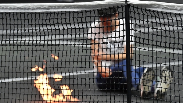 A protester invaded the court and appeared to set his arm alight