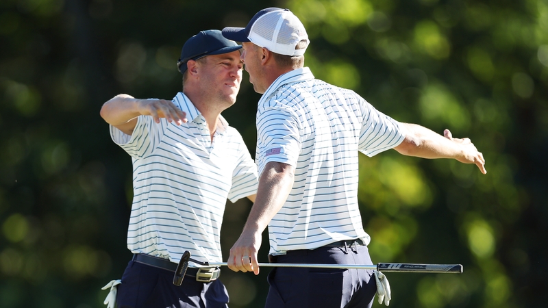 Justin Thomas (L) and Jordan Spieth celebrate winning 2&1 over Adam Scott and Cam Davis