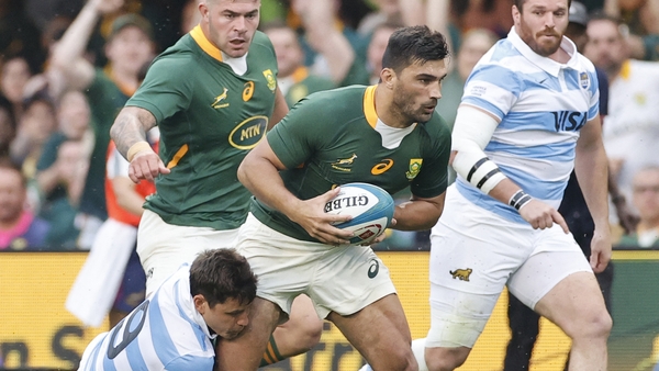 Damian de Allende is tackled by Argentina scrum-half Gonzalo Bertranou