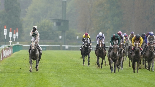Luke Morris stands up in his stirrups to celebrate the victory of the remarkable mare Alpinista at Longchamp