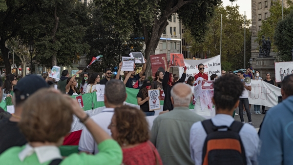 People attend a solidarity protest for Mahsa Amini in Barcelona, Spain, today