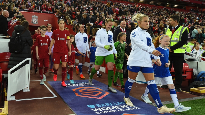 Courtney Brosnan, in the green kit, emerges from the tunnel at Anfield