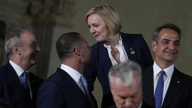 Micheál Martin and Liz Truss speak during a group photo for a meeting of the European Political Community at Prague Castle
