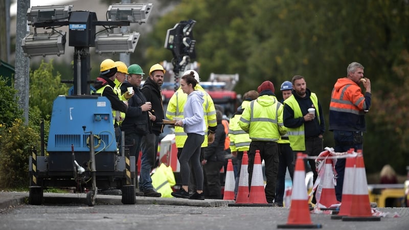 A local hands out drinks and food to emergency services at the scene of the Applegreen service station explosion