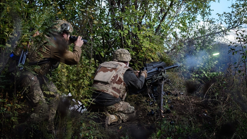 A soldier of Ukraine's 5th Regiment of Assault Infantry fires a US-made MK-19 automatic grenade launcher towards Russian positions