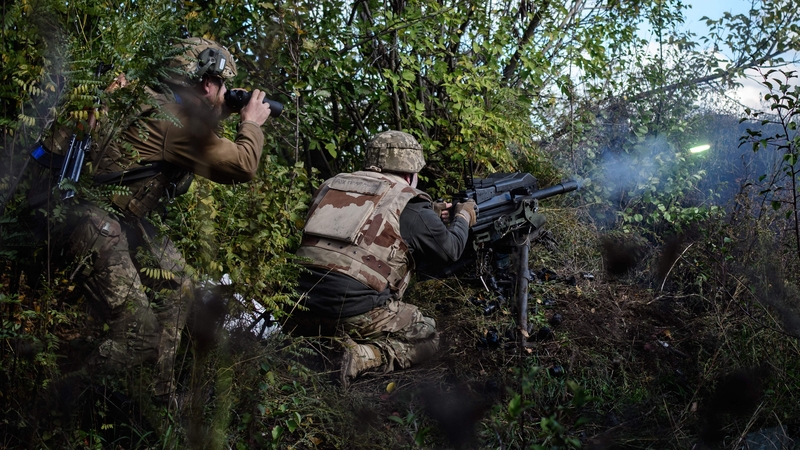 A Ukrainian soldier fires an automatic grenade launcher towards Russian positions less than 800 metres away at the frontline near Toretsk