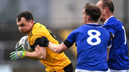Conor O'Donnell Snr of St Eunan's in action against Ciaran Thompson, 8, and Eoin Waide of Naomh Conaill