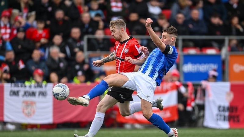 Derry's Jamie McGonigle is tackled by Callum McNamara of Treaty United