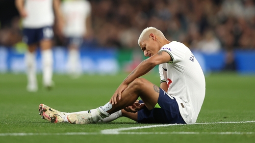 Richarlison examines his calf after suffering an injury against Everton on Saturday