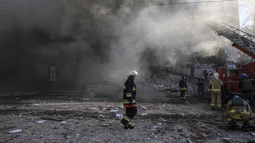 Firefighters conduct work in a destroyed building after the Russian drone attacks in Kyiv yesterday