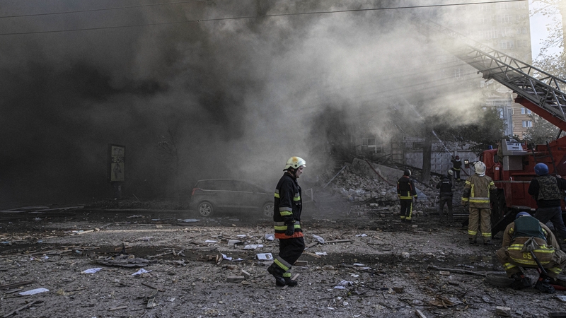 Firefighters conduct work in a destroyed building after the Russian drone attacks in Kyiv yesterday