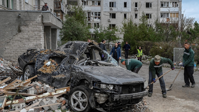 People clean rubble away after a rocket attack in Mykolaiv yesterday