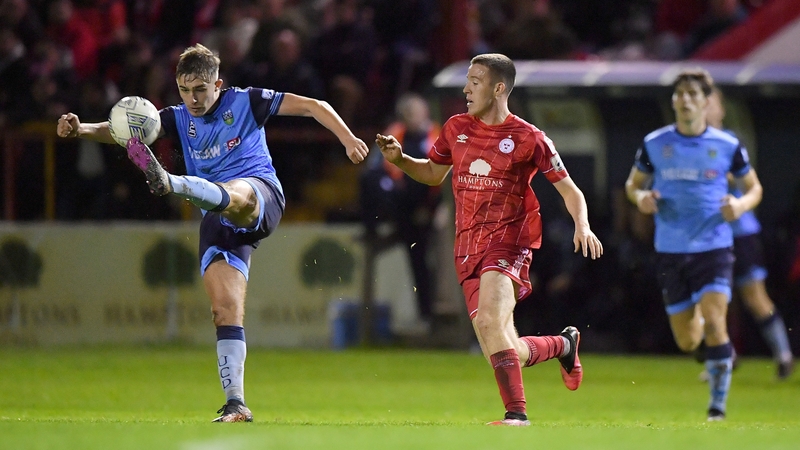 Evan Caffrey clearing the ball under pressure from Shelbourne's Jack Moylan