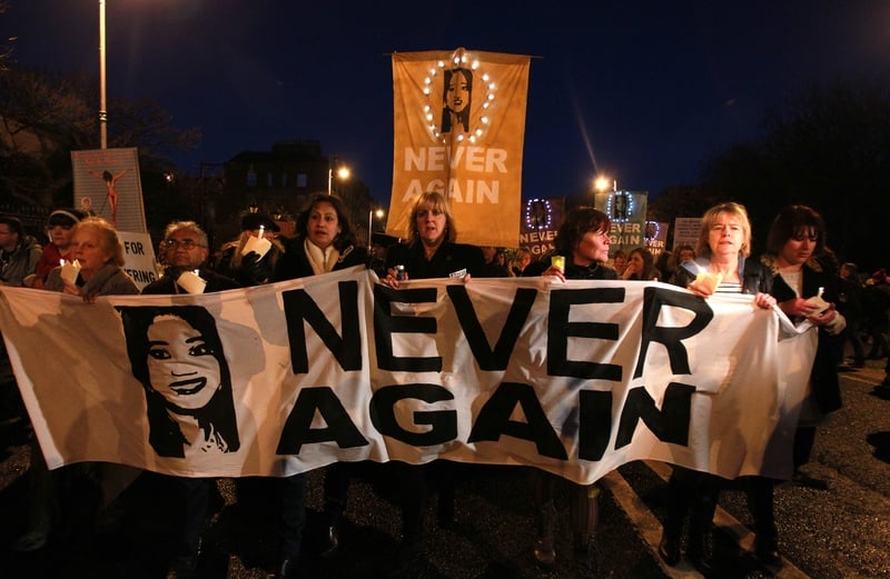 Demonstrators hold placards in support of legislative change on abortion in 2012